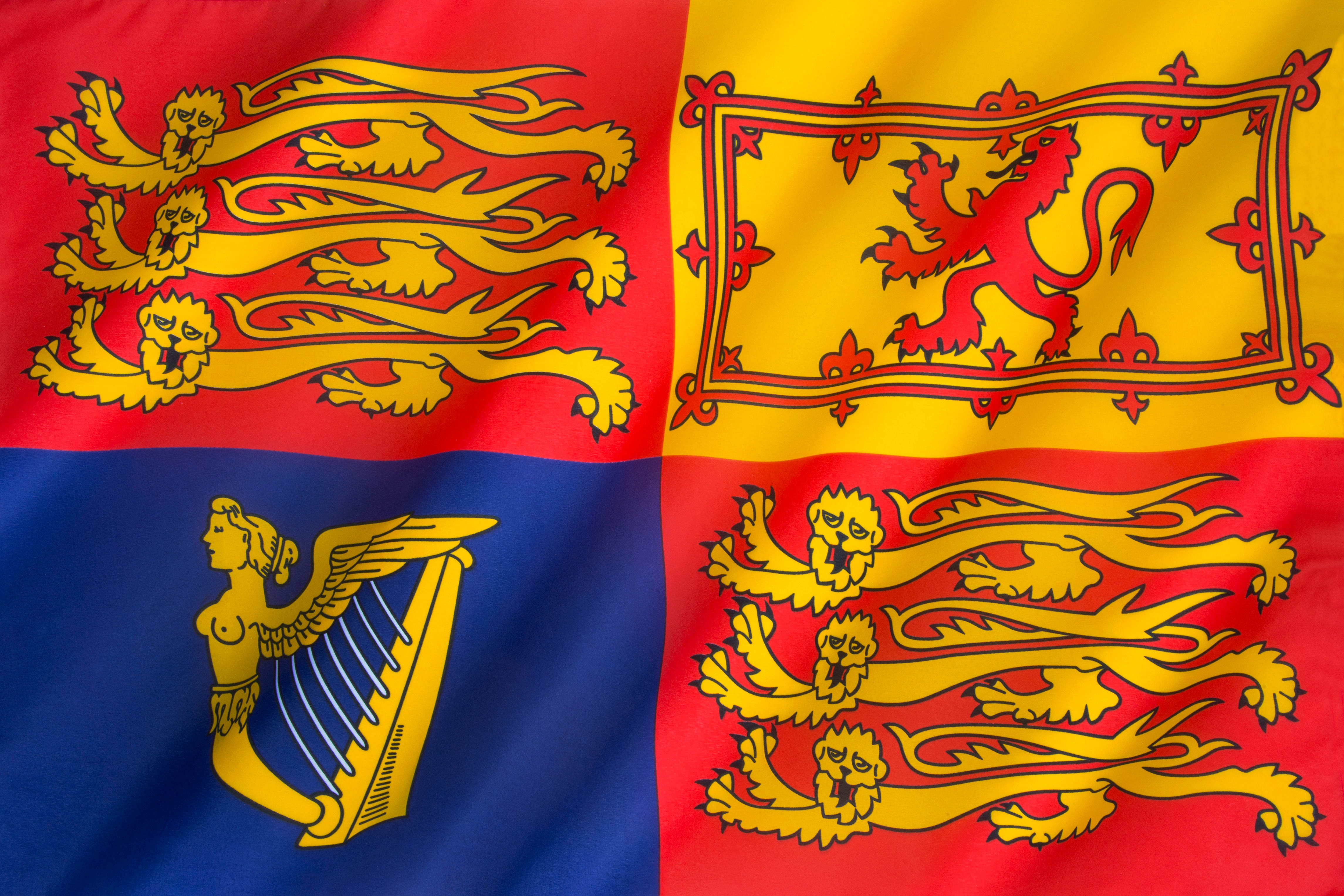 A red, yellow and blue flag with intricate symbolic designs
