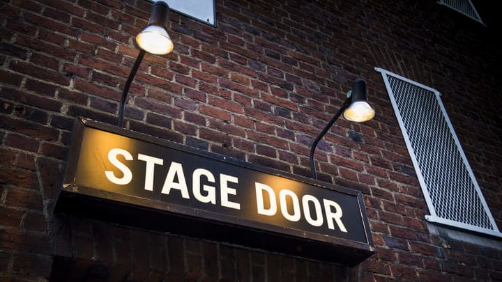 Stage door sign outside a theater